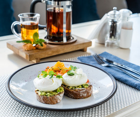 sandwich with avocado and poached eggs