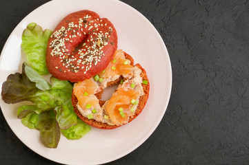 red bagel with salmon pate and smoked salmon