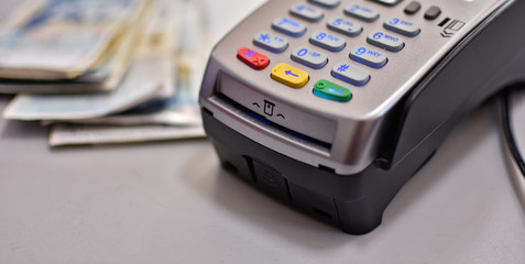 Bank terminal for payment purchases in store by credit cards and paper check receipt. Device for processing payments e-commerce