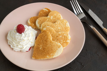 Berry homemade pancakes on a black background.