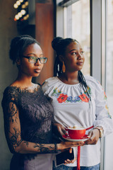 Girls in the cafe.Beautiful girls with a phone. Girls rest in the cafe