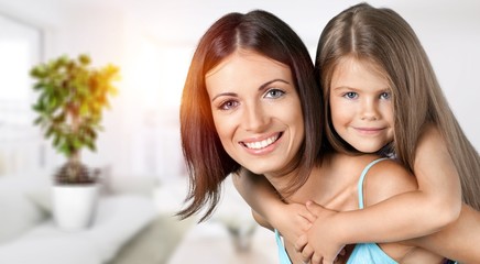 Young family at home smiling at camera