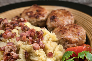 Minced meat cutlets with boiled sauerkraut.