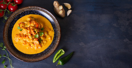 Creamy rich spicy shrimp curry. Seafood dish. View from above, top view. Copy space