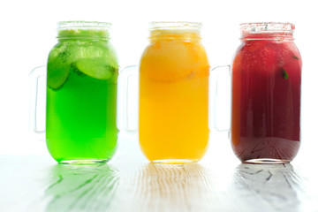 Lemonade with fruit in glass mugs.