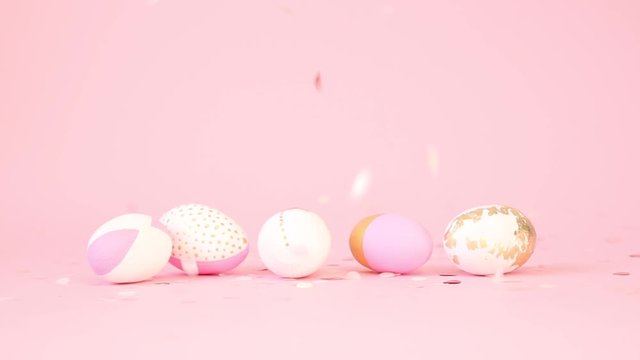 Minimal creative composition with easter white pink wooden eggs decorated with a gold pattern on a pink background. A multi-colored gold and pink candy flies down. Happy Easter concept.