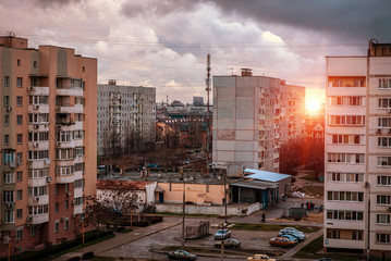  evening city with colorful clouds and smoke.