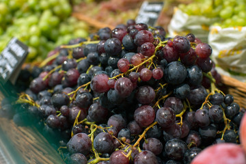 grapes red, white, raisins, sale in a grocery supermarket