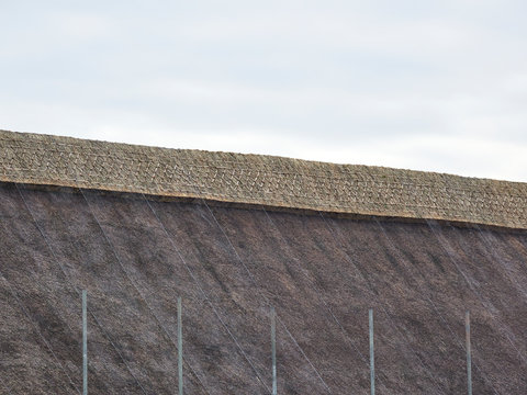 Close up of the new thatch ridge on a church in Pakefield with scaffolding is still in place.