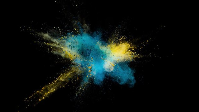 Colored powder explosion, abstract close up dust isolated on black background in slow motion