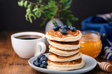 Pancakes with blueberries and honey. Stack of tasty buttermilk pancakes. Horizontal composition, breakfast food