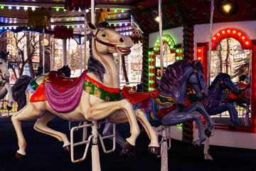 Fototapeta premium merry-go-round, close-up plastic vintage horse in amusement park