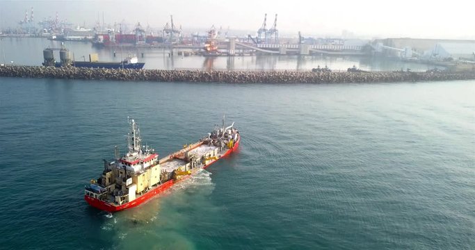 Aerial footage over Sand dredging ship with Ashdod port in Background Drone view over Sand dredging ship with Ashdod port in Backgroun, Israel