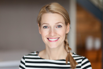 Close up Of A Smiling Caucasien blond woman in the living room	