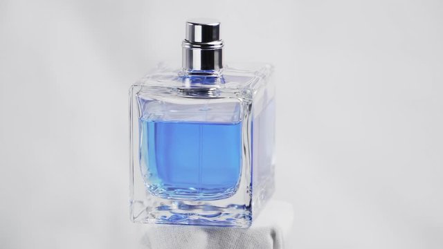 isolated on white with 360 degrees in rotation of a Men blue perfume. Cologne. Bottle spray