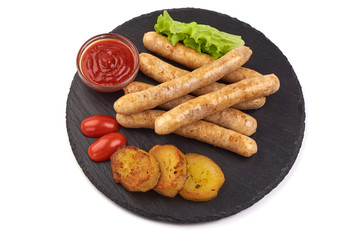 Grilled Chicken Sausages with tomato sauce and salad leaves, on a stone plate, isolated on white background