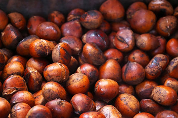 Hot roasted chestnuts background, street xmas vendor