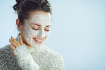 happy elegant female with white facial mask