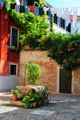 Fototapeta na wymiar Picturesque view of a medieval courtyard and old well, Venice, Italy