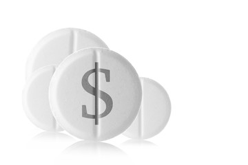 White round tablet with a dollar sign on a white background. Medicines on a white mirror surface. closeup.