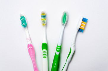 Various toothbrushes on a white background.