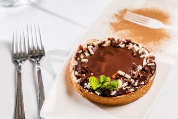 chocotale tart with nuts and mint