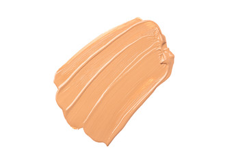 Bright beige smear of foundation in the form of a group of diagonal strokes isolated on a white background.