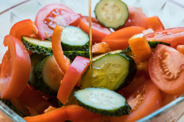 Vegetable salad with olive oil. Sliced vegetables close-up.