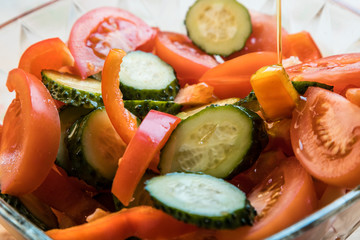 Vegetable salad with olive oil. Sliced vegetables close-up.