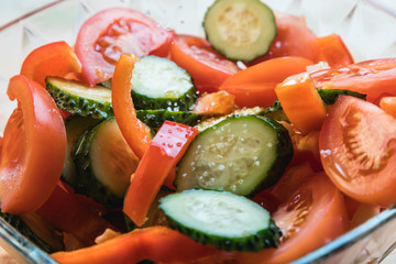 Vegetable salad with olive oil. Sliced vegetables close-up.