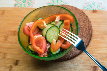 Vegetable salad with olive oil. Sliced vegetables close-up.