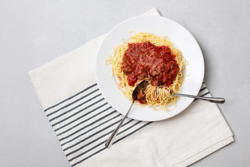 Homemade Spaghetti with Meat Sauce in White Plate on Neutral Gray Background