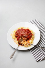 Homemade Spaghetti with Meat Sauce in White Plate on Neutral Gray Background