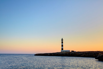 Fototapeta na wymiar Cap d'Artrutx Lighthouse, located in the extreme south-western point of the island adjacent to the larger resort of Cala en Bosch, Menorca,Balearic Islands, Spain