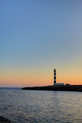 Cap d'Artrutx Lighthouse, located in the extreme south-western point of the island adjacent to the larger resort of Cala en Bosch, Menorca,Balearic Islands, Spain