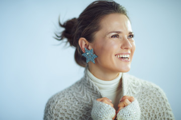 happy housewife with snowflake earring looking at copy space