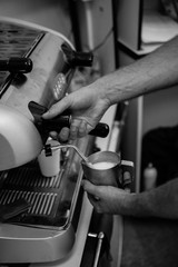 Barista prepares coffee, the process of making coffee in the cafe, the hands of the Barista close-up