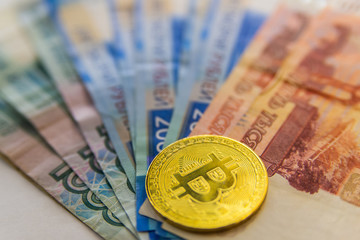 Golden Bitcoins close-up on euro currency background. High resolution photo