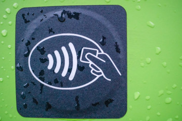 Close-up of a contactless payment sign on a contactless card machine for refueling cars