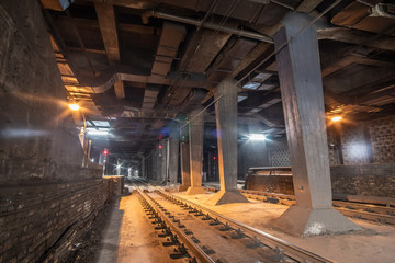 Big empty railway tunnel with many tracks near the underground railway station. Inside railway...