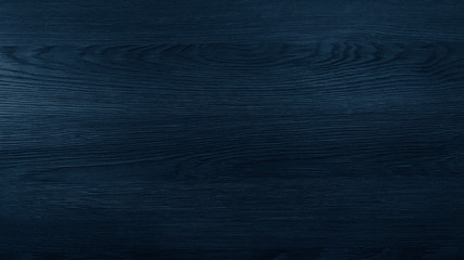 Wood texture in blue classic color. Dark wood, wooden dark background. Dark room with wooden walls.