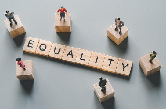 gender equality, miniature men and women stand around "equality" word