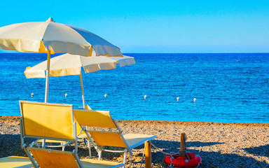 Landscape of Chia Beach with umbrellas and Blue Waters of the Mediterranean Sea in Province of Cagliari in South Sardinia in Italy. Scenery and nature. Mixed media.