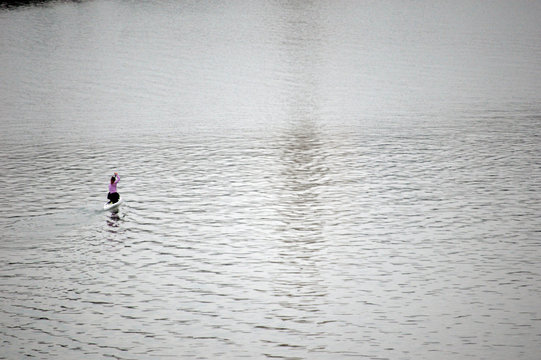 A woman riding a rowing boat on the water of river Guadalquivir, Seville