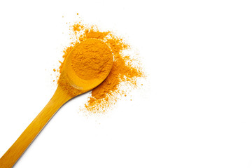 Dry turmeric powder and wooden spoon on  isolated white background.Close-up of powder orange color turmeric.top view and copy space