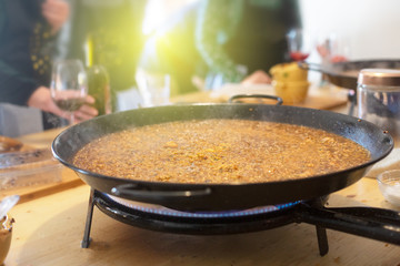 Paella pan with traditional Spanish food usually prepared with rice, meat, seafood. Horizontal orientation