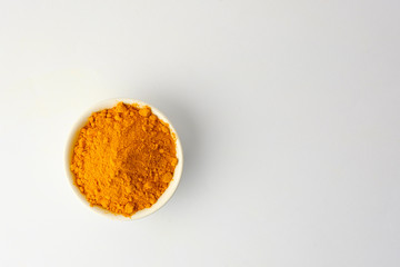 Dry turmeric powder isolated on white background.Close-up of powder orange color turmeric.top view and copy space