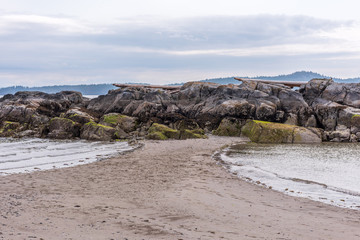 View over inlet, ocean and island with boat and mountains in beautiful British Columbia. Canada.