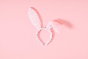 Easter pink minimal composition. Easter decoration, bunny ears on pastel pink background. Flat lay, top view, copy space