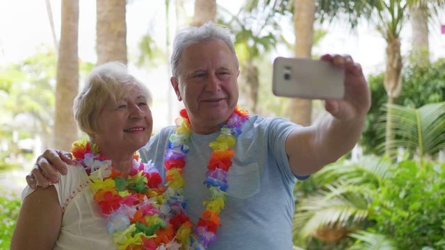 Senior Couple Taking A Selfie photo in Hawaii in 4K Slow motion 60fps